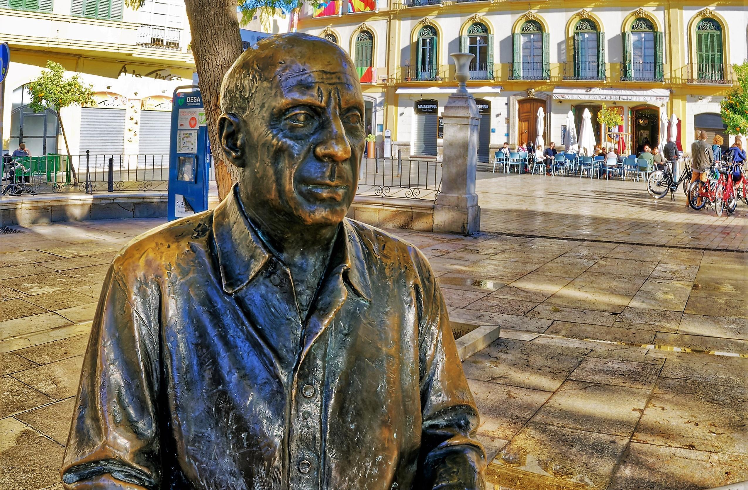 Pablo Picasso in the Plaza de Merced in Málaga with Museo Casa Natal Picasso in the background in