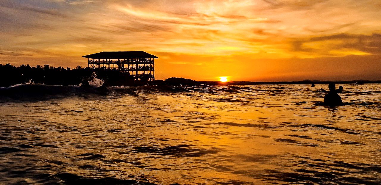 Surfing at sunset on Siargao Island, the Philippines