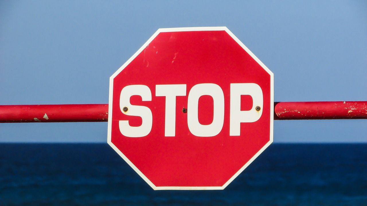 Stop sign with ocean in the background